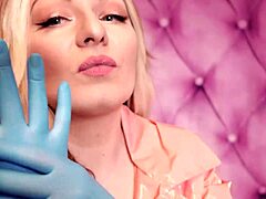 Aria Grander, a seductive MILF, dons a fetishistic attire including a pink PVC coat and blue nitrile gloves, showcasing her stunning curves in this homemade video.
