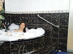 Sensual and seductive MILF flaunts her wet ass in a hot bath
